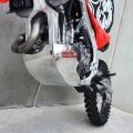 B&B aluminium bash plate fitted to a red off-road motorcycle