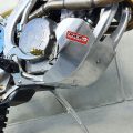 Black motorcycle bash plate covering the underside of the engine