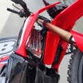 Close-up of radiator protection brace fitted to red dirt bike