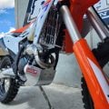Polished B&B bash plate fitted to a KTM 250 XCF dirt bike