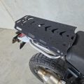 Black B&B solo luggage rack with grab handles fitted to a motorcycle