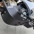 Black B&B bash plate fitted beneath an off-road motorcycle engine