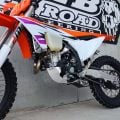 Polished B&B bash plate fitted to a red Honda dirt bike